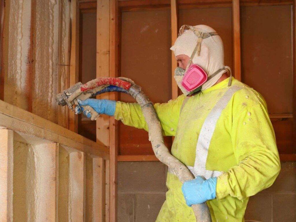 worker spraying on walls