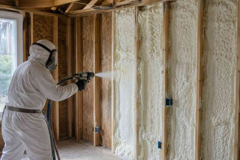 worker spraying on walls